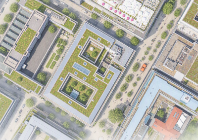 Luftbild eines großen Gebäudeblocks mit begrünten Dachflächen und umliegender Innenstadtbebauung.
